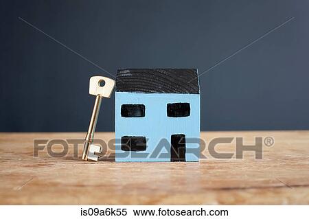 Key leaning on model house View Large Photo Image Stock Photography - Key leaning on model house. Fotosearch