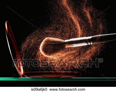 Stock Image - Makeup brush tapping off powder. Fotosearch
