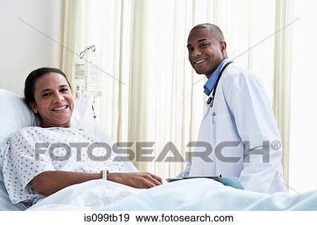 Male doctor and female patient in hospital View Large Photo Image Stock Photo - Male doctor and female patient in hospital. Fotosearch