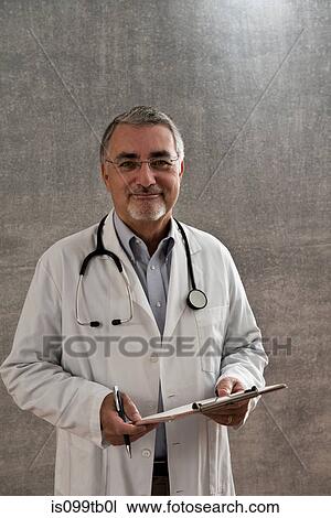 Male doctor with clipboard View Large Photo Image Stock Image - Male doctor with clipboard. Fotosearch