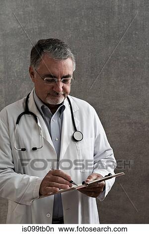 Picture - Male doctor writing on chart. Fotosearch