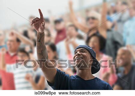 Man at sports game, pointing up View Large Photo Image Stock Image - Man at sports game, pointing up. Fotosearch