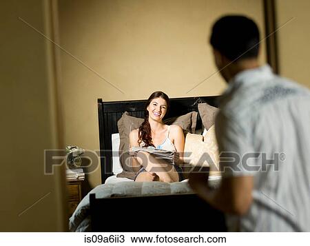Man greeting girlfriend in bedroom View Large Photo Image Stock Image - Man greeting girlfriend in bedroom. Fotosearch