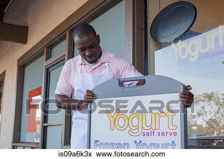 Man opening frozen yogurt store View Large Photo Image Stock Photo - Man opening frozen yogurt store. Fotosearch