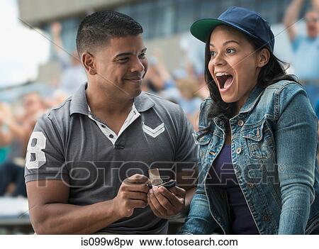 Man proposing to girlfriend at sports game View Large Photo Image Stock Photo - Man proposing to girlfriend at sports game. Fotosearch