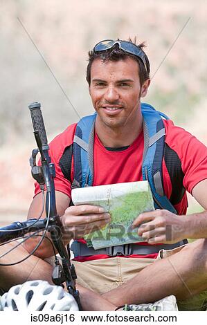 Man reading map on mountain bike View Large Photo Image Stock Photograph - Man reading map on mountain bike. Fotosearch