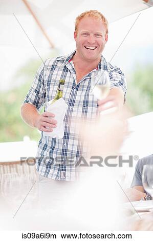 Picture - Man setting table outdoors. Fotosearch