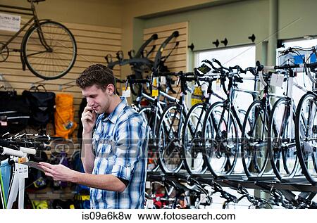 Man shopping in bicycle shop View Large Photo Image Stock Photo - Man shopping in bicycle shop. Fotosearch