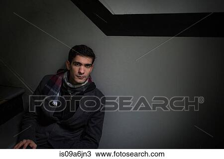 Stock Image - Man sitting on steps. Fotosearch