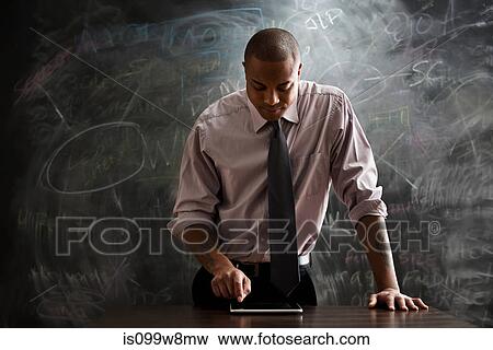 Stock Photo - Man using digital tablet. Fotosearch