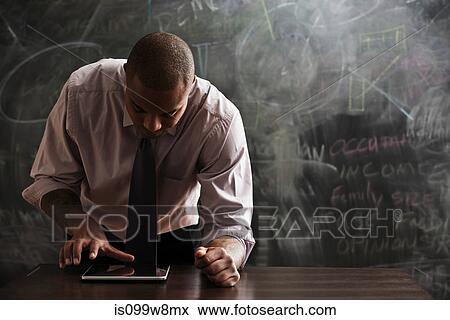 Man using digital tablet View Large Photo Image Stock Photo - Man using digital tablet. Fotosearch