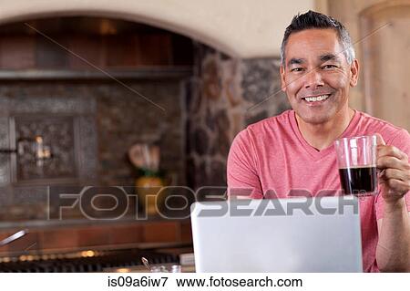 Man using laptop at breakfast View Large Photo Image Stock Photo - Man using laptop at breakfast. Fotosearch