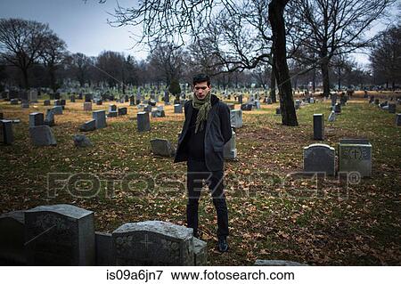 Stock Photo - Man visiting graveyard. Fotosearch