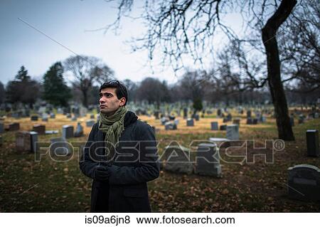 Stock Photo - Man visiting graveyard. Fotosearch