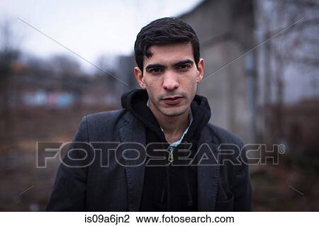 Stock Image - Man walking outdoors. Fotosearch