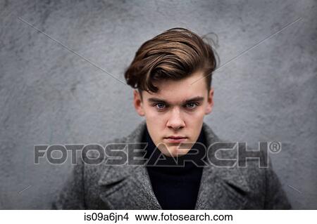 Picture - Man wearing coat outdoors. Fotosearch