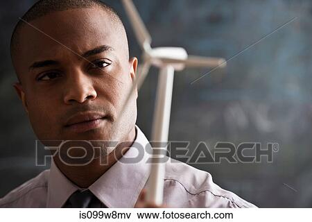 Man with model wind turbine View Large Photo Image Stock Photo - Man with model wind turbine. Fotosearch