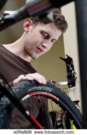 Mechanic working in bicycle repair shop View Large Photo Image Stock Photograph - Mechanic working in bicycle repair shop. Fotosearch