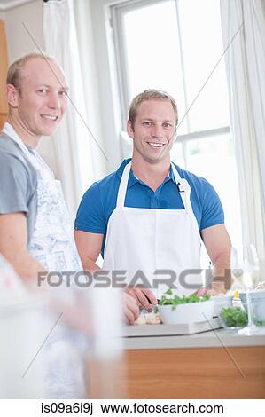Men cooking together in kitchen View Large Photo Image Stock Image - Men cooking together in kitchen. Fotosearch