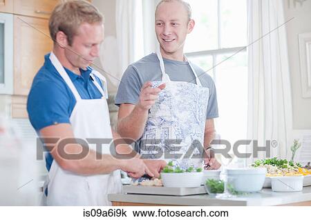 Men cooking together in kitchen View Large Photo Image Stock Image - Men cooking together in kitchen. Fotosearch