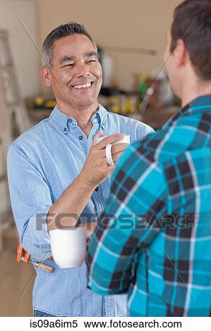 Men drinking coffee together in garage View Large Photo Image Stock Photography - Men drinking coffee together in garage. Fotosearch