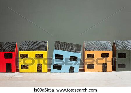 Stock Image - Model house sinking on counter. Fotosearch