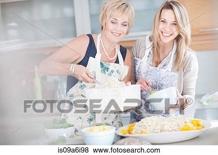 Mother and daughter cooking in kitchen View Large Photo Image Stock Photo - Mother and daughter cooking in kitchen. Fotosearch