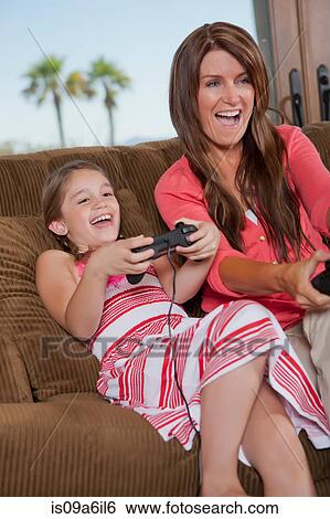 Mother and daughter playing video games View Large Photo Image Stock Photograph - Mother and daughter playing video games. Fotosearch