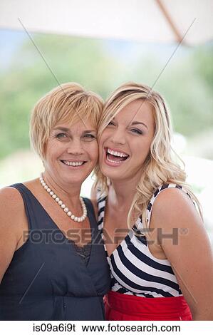 Mother and daughter smiling outdoors View Large Photo Image Stock Photograph - Mother and daughter smiling outdoors. Fotosearch
