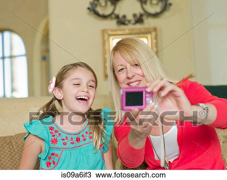 Stock Image - Mother and daughter taking picture. Fotosearch