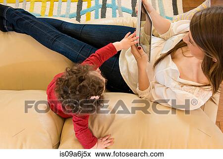 Mother and daughter with tablet computer View Large Photo Image Stock Photo - Mother and daughter with tablet computer. Fotosearch
