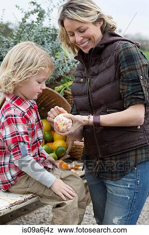 Mother and son at farmer's market View Large Photo Image Stock Photo - Mother and son at farmer's market. Fotosearch