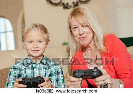 Mother and son playing video games View Large Photo Image Stock Image - Mother and son playing video games. Fotosearch