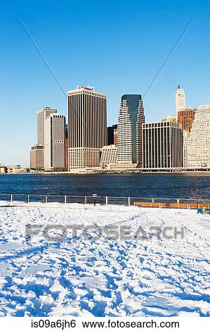 Stock Photograph - New York City skyline and snowy park. Fotosearch