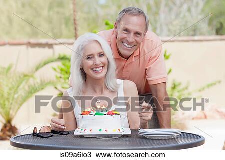 Stock Image - Older couple celebrating birthday. Fotosearch