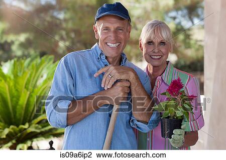 Stock Image - Older couple gardening together. Fotosearch