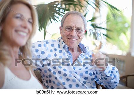Stock Photo - Older couple having wine together. Fotosearch