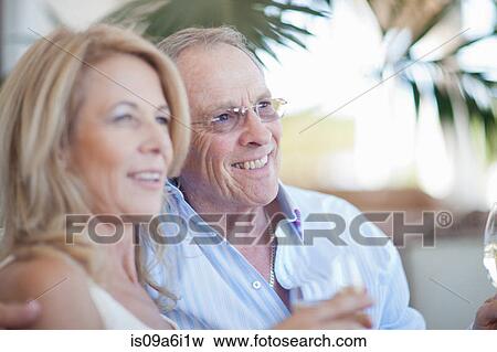 Stock Photo - Older couple having wine together. Fotosearch