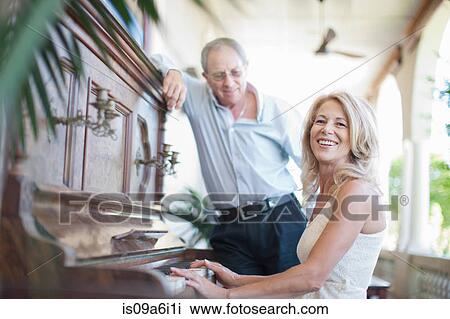 Stock Image - Older couple playing piano. Fotosearch