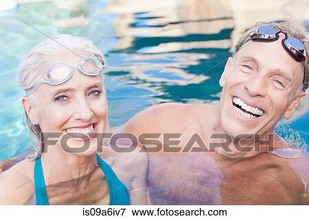 Older couple swimming in pool View Large Photo Image Stock Photo - Older couple swimming in pool. Fotosearch