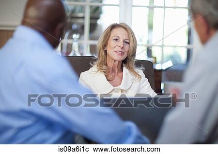 Older friends talking in living room View Large Photo Image Stock Image - Older friends talking in living room. Fotosearch