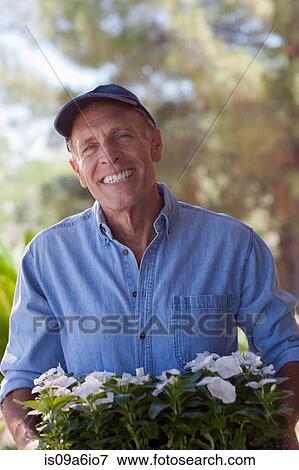Stock Photo - Older man gardening outdoors. Fotosearch