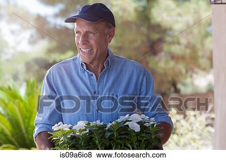 Older man gardening outdoors View Large Photo Image Stock Photo - Older man gardening outdoors. Fotosearch