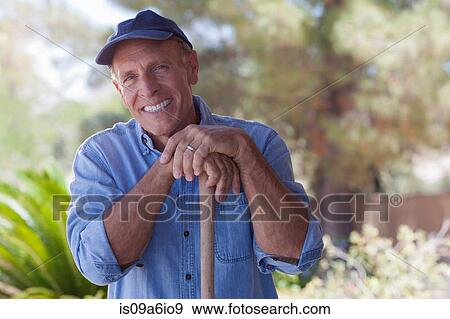 Stock Photo - Older man gardening outdoors. Fotosearch