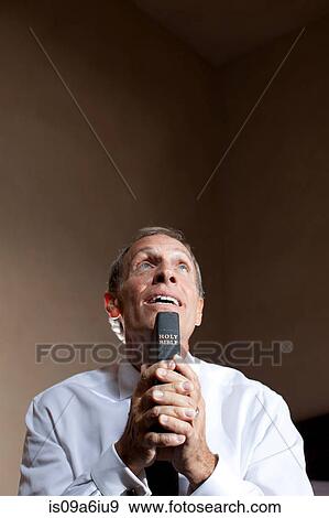 Older man holding bible View Large Photo Image Stock Photo - Older man holding bible. Fotosearch