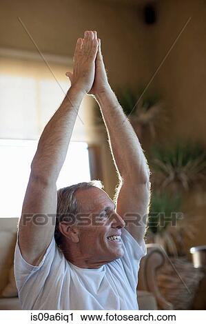 Older man practicing yoga at home View Large Photo Image Stock Image - Older man practicing yoga at home. Fotosearch