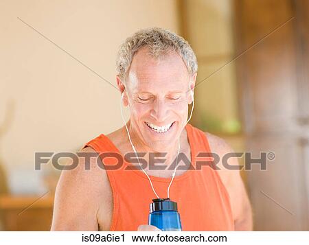 Stock Image - Older man working out at home. Fotosearch
