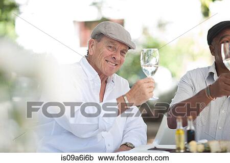 Older men having wine together View Large Photo Image Stock Image - Older men having wine together. Fotosearch