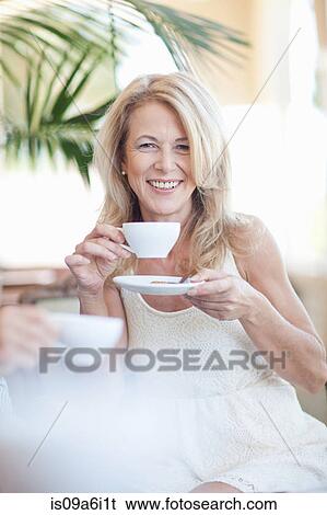 Older woman having cup of coffee View Large Photo Image Stock Photograph - Older woman having cup of coffee. Fotosearch