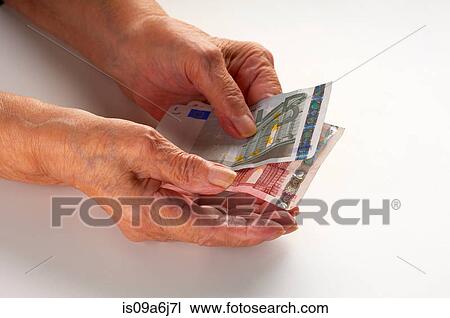 Older woman holding Euro notes View Large Photo Image Stock Image - Older woman holding Euro notes. Fotosearch